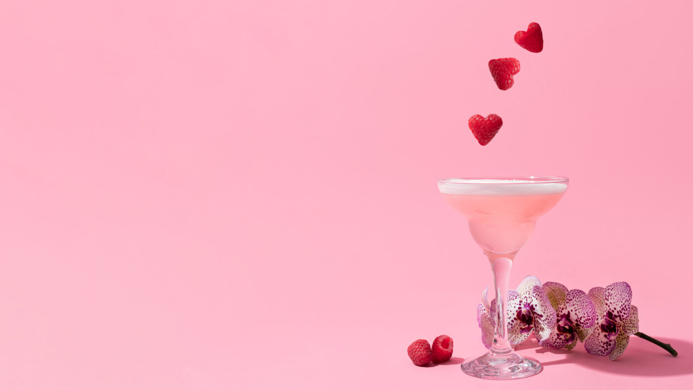 pink background with a martini glass