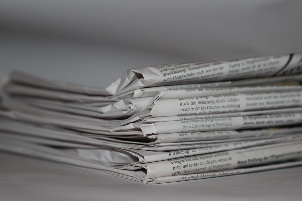 A stack of newspapers in black and white